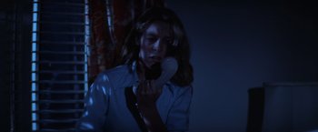 Movie still from “Halloween” (1978), directed by John Carpenter – A woman holding a phone up to her ear; Close Up shot, High angle
