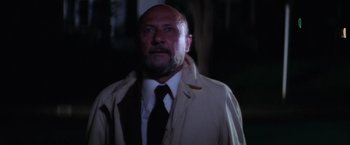 Movie still from “Halloween” (1978), directed by John Carpenter – A man wearing a white shirt and a tie; Close Up shot, Low angle