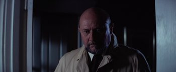Movie still from “Halloween” (1978), directed by John Carpenter – A man with a bald head wearing a tie; Close Up shot, Low angle