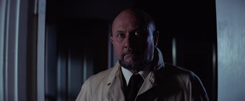 Movie still from “Halloween” (1978), directed by John Carpenter – A man with a bald head wearing a white coat; Close Up shot, Low angle