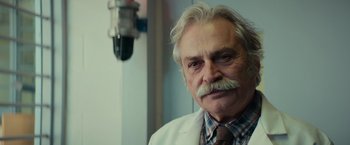Movie still from “Halloween” (2018), directed by David Gordon Green – An older man with a mustache and a white coat; Close Up shot, Low angle