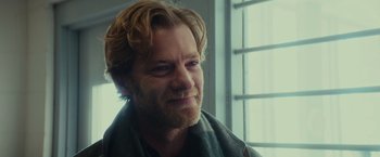 Movie still from “Halloween” (2018), directed by David Gordon Green – A person with a beard wearing a scarf; Close Up shot, Over the shoulder angle