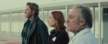 Movie still from “Halloween” (2018), directed by David Gordon Green – Three people standing in a line looking at something; Medium shot, Low angle