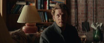 Movie still from “Halloween” (2018), directed by David Gordon Green – A person wearing a jacket in a room; Close Up shot, Over the shoulder angle