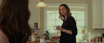 Movie still from “Halloween” (2018), directed by David Gordon Green – A woman standing in a kitchen holding a mug; Medium shot, Over the shoulder angle