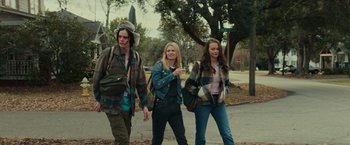 Movie still from “Halloween” (2018), directed by David Gordon Green – A group of people walking down a street; Medium shot, Low angle