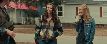 Movie still from “Halloween” (2018), directed by David Gordon Green – A woman standing on the side of the street; Medium shot, Over the shoulder angle