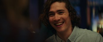 Movie still from “Halloween” (2018), directed by David Gordon Green – A person with long brown hair smiling; Close Up shot, Over the shoulder angle