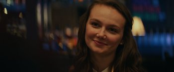 Movie still from “Halloween” (2018), directed by David Gordon Green – A person smiling for a picture; Close Up shot, Over the shoulder angle