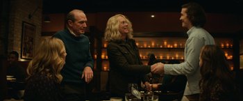 Movie still from “Halloween” (2018), directed by David Gordon Green – A man and a woman shaking hands over a glass of wine; Medium shot, Over the shoulder angle
