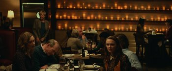 Movie still from “Halloween” (2018), directed by David Gordon Green – A group of people sitting at a table in a restaurant; Medium shot, Over the shoulder angle