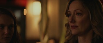 Movie still from “Halloween” (2018), directed by David Gordon Green – A person wearing glasses in a room; Close Up shot, Over the shoulder angle