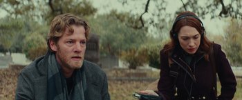 Movie still from “Halloween” (2018), directed by David Gordon Green – A man and a woman sitting on a bench; Medium shot, Over the shoulder angle
