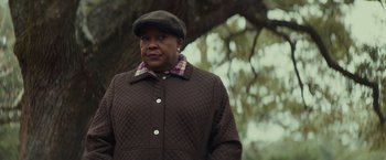 Movie still from “Halloween” (2018), directed by David Gordon Green – An older black woman wearing a brown jacket and a hat; Close Up shot, Over the shoulder angle