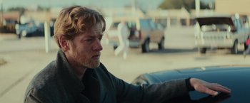 Movie still from “Halloween” (2018), directed by David Gordon Green – A person sitting in a car on the street; Close Up shot, Over the shoulder angle
