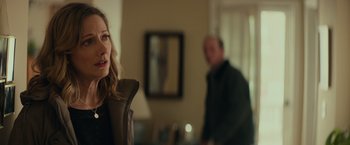 Movie still from “Halloween” (2018), directed by David Gordon Green – A man and a woman in a living room; Medium shot, Over the shoulder angle