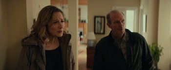 Movie still from “Halloween” (2018), directed by David Gordon Green – A woman and a man standing next to each other in a room; Medium shot, Over the shoulder angle