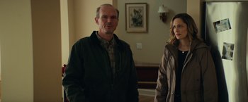 Movie still from “Halloween” (2018), directed by David Gordon Green – A man and a woman standing next to each other in a room; Medium shot, Over the shoulder angle