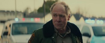 Movie still from “Halloween” (2018), directed by David Gordon Green – A person wearing a jacket; Close Up shot, Over the shoulder angle