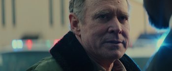 Movie still from “Halloween” (2018), directed by David Gordon Green – An older man wearing a green jacket looking to his left; Close Up shot, Over the shoulder angle