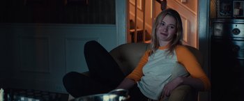 Movie still from “Halloween” (2018), directed by David Gordon Green – A woman sitting on a chair in a living room; Medium shot, Over the shoulder angle