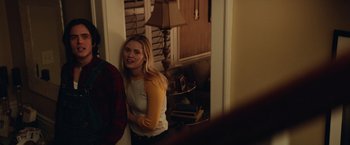 Movie still from “Halloween” (2018), directed by David Gordon Green – A woman standing in front of a mirror in a living room; Medium shot, Over the shoulder angle