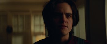 Movie still from “Halloween” (2018), directed by David Gordon Green – A person with long brown hair is looking at the camera; Close Up shot, Low angle