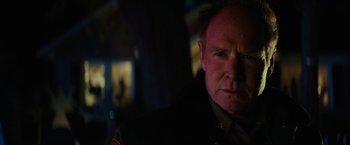 Movie still from “Halloween” (2018), directed by David Gordon Green – A person wearing a military uniform; Close Up shot, Over the shoulder angle