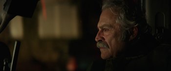Movie still from “Halloween” (2018), directed by David Gordon Green – An older man with a mustache looking to his left; Close Up shot, Low angle