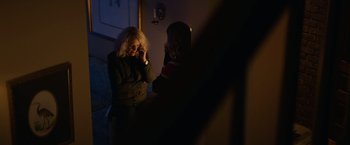 Movie still from “Halloween” (2018), directed by David Gordon Green – Two women standing next to each other in the dark; Medium shot, Over the shoulder angle