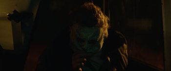 Movie still from “Halloween” (2018), directed by David Gordon Green – A man with a mask on looking down at his face; Close Up shot, High angle
