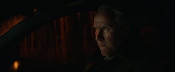 Movie still from “Halloween” (2018), directed by David Gordon Green – An older man looking into the distance in the dark; Close Up shot, Low angle