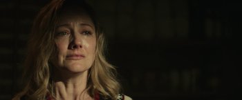 Movie still from “Halloween” (2018), directed by David Gordon Green – A person with her eyes closed; Close Up shot, Over the shoulder angle