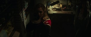 Movie still from “Halloween” (2018), directed by David Gordon Green – A woman in a dark room holding a cat; Medium shot, Low angle