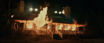 Movie still from “Halloween” (2018), directed by David Gordon Green – A house on fire at night with lights on; Extreme Wide shot, Low angle