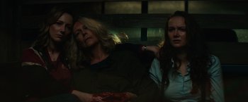Movie still from “Halloween” (2018), directed by David Gordon Green – Two women sitting next to each other on a bench; Medium shot, Over the shoulder angle