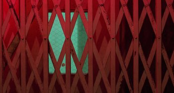 Movie still from “Halloween 4: The Return of Michael Myers” (1988), directed by Dwight H. Little – A red gate with a light blue background; Extreme Close Up shot, Overhead angle