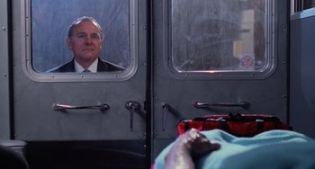 Movie still from “Halloween 4: The Return of Michael Myers” (1988), directed by Dwight H. Little – A man looking at himself in the mirror of a bus; Medium shot, Over the shoulder angle