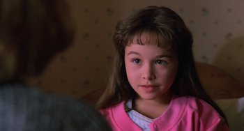 Movie still from “Halloween 4: The Return of Michael Myers” (1988), directed by Dwight H. Little – A little girl in a pink shirt looking at the camera; Close Up shot, High angle