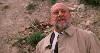 Movie still from “Halloween 4: The Return of Michael Myers” (1988), directed by Dwight H. Little – An older man wearing a tan jacket and a tie; Close Up shot, Low angle