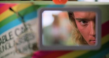 Movie still from “Halloween 4: The Return of Michael Myers” (1988), directed by Dwight H. Little – A man looking at himself in a mirror; Extreme Close Up shot, Low angle