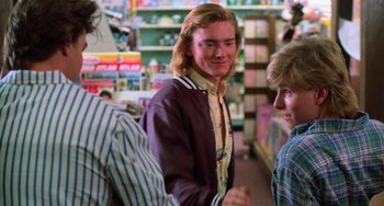 Movie still from “Halloween 4: The Return of Michael Myers” (1988), directed by Dwight H. Little – A man with blonde hair standing next to a woman; Medium shot, Over the shoulder angle