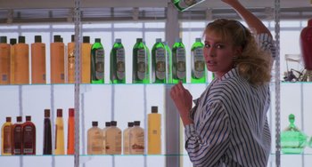 Movie still from “Halloween 4: The Return of Michael Myers” (1988), directed by Dwight H. Little – A woman standing in front of a display case; Medium shot, Low angle
