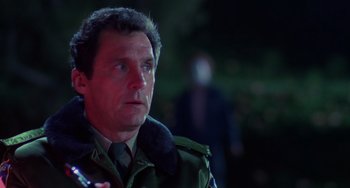 Movie still from “Halloween 4: The Return of Michael Myers” (1988), directed by Dwight H. Little – A person wearing a jacket; Close Up shot, Over the shoulder angle