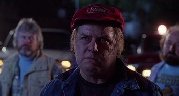 Movie still from “Halloween 4: The Return of Michael Myers” (1988), directed by Dwight H. Little – A person wearing a hat; Close Up shot, Low angle