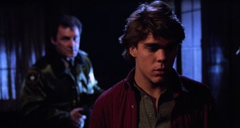Movie still from “Halloween 4: The Return of Michael Myers” (1988), directed by Dwight H. Little – A man in a red jacket and a man in a green jacket; Close Up shot, Over the shoulder angle