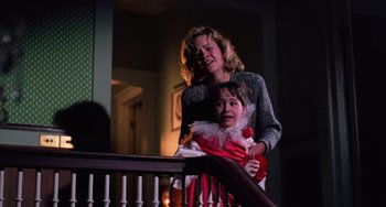 Movie still from “Halloween 4: The Return of Michael Myers” (1988), directed by Dwight H. Little – A woman and a child standing next to a railing; Medium shot, Low angle