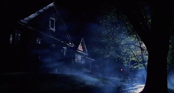 Movie still from “Halloween 4: The Return of Michael Myers” (1988), directed by Dwight H. Little – A house is lit up at night by a street light; Extreme Wide shot, Low angle