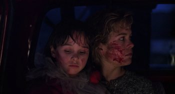 Movie still from “Halloween 4: The Return of Michael Myers” (1988), directed by Dwight H. Little – Two people with blood on their faces and their eyes; Close Up shot, Low angle