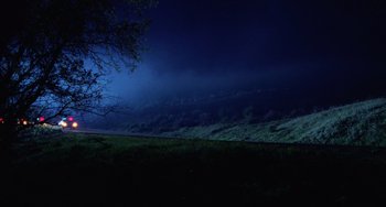 Movie still from “Halloween 4: The Return of Michael Myers” (1988), directed by Dwight H. Little – A dark sky with a cloud filled sky at night; Extreme Wide shot, Low angle